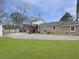 Lovely backyard showcases a brick home, a detached garage, and a wooden deck perfect for outdoor relaxation and entertainment at 760 Royle Rd, Ladson, SC 29456