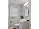 Bathroom featuring a white vanity, oval mirror, and natural light from a window at 760 Royle Rd, Ladson, SC 29456