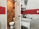 Functional bathroom with a toilet, sink, and raw-wood walls, ideal for use in the shop or hobby space at 760 Royle Rd, Ladson, SC 29456