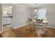 Dining room with hardwood floors features a white table and chairs and chandelier at 760 Royle Rd, Ladson, SC 29456