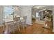 Dining area next to the open living room features a white table with views to the fireplace at 760 Royle Rd, Ladson, SC 29456