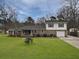 Charming two-story brick home with a well-manicured front lawn, mature trees, and attached one car garage at 760 Royle Rd, Ladson, SC 29456