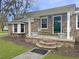 Inviting front porch with classic brick stairs, white chairs, and a covered entrance at 760 Royle Rd, Ladson, SC 29456