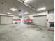 Vast garage interior with multiple roll-up doors, shelving, and workspace, perfect for storage, projects, and hobbies at 760 Royle Rd, Ladson, SC 29456