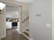 Hallway leading to the kitchen with brown tile floors and white walls at 760 Royle Rd, Ladson, SC 29456