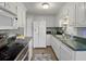 Bright kitchen with stainless appliances, white cabinets, and green countertops at 760 Royle Rd, Ladson, SC 29456