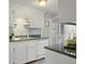 Galley kitchen with updated countertops features white cabinets and modern appliances at 760 Royle Rd, Ladson, SC 29456