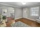 Cozy living room with hardwood floors, gray walls, natural light and an open view to the dining area at 760 Royle Rd, Ladson, SC 29456