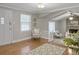 Bright living room features vaulted ceilings, a brick fireplace, and seamless access to other living spaces at 760 Royle Rd, Ladson, SC 29456