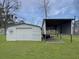 Durable metal storage shed with a covered area provides ample space for equipment and tools on a large lot at 760 Royle Rd, Ladson, SC 29456