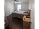 Bedroom with dark floors, ceiling fan, natural light, and closet space provides a comfortable and functional space at 7955 Timbercreek Ln # 1807, North Charleston, SC 29418
