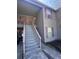 Exterior staircase leading to residential units with shuttered windows above at 7955 Timbercreek Ln # 1807, North Charleston, SC 29418