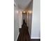 Hallway with wood-look flooring, neutral paint leads to various rooms in this inviting home at 7955 Timbercreek Ln # 1807, North Charleston, SC 29418