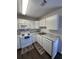 Bright kitchen with white appliances, cabinets, and gray countertops provides a clean and modern aesthetic at 7955 Timbercreek Ln # 1807, North Charleston, SC 29418