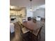 Open living and dining area with dark floors, seamlessly connected to the kitchen at 7955 Timbercreek Ln # 1807, North Charleston, SC 29418