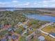 Aerial view showcasing a residential neighborhood with waterfront access and surrounding greenery at 95 Plymouth Ave, Charleston, SC 29412
