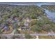Aerial view of a neighborhood with waterfront properties and lush trees at 95 Plymouth Ave, Charleston, SC 29412