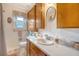 Bathroom with a light countertop, wooden cabinetry and white walls at 95 Plymouth Ave, Charleston, SC 29412