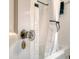 Close-up of a classic door handle in a bathroom, showing a white shower curtain in the background at 95 Plymouth Ave, Charleston, SC 29412