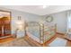 Light-filled bedroom with white walls, vintage furniture, and hardwood floors at 95 Plymouth Ave, Charleston, SC 29412