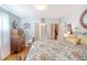 Cozy bedroom features hardwood floors, a floral bedspread, and a vintage wooden dresser with natural light at 95 Plymouth Ave, Charleston, SC 29412