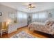 Bedroom featuring hard wood floors, ceiling fan, and abundant natural light from large windows at 95 Plymouth Ave, Charleston, SC 29412