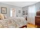Comfortable bedroom with a floral patterned bedspread, hardwood floors, and ample natural light at 95 Plymouth Ave, Charleston, SC 29412