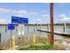 Public boat launch and dock featuring multiple information and warning signs for boaters at 95 Plymouth Ave, Charleston, SC 29412