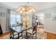 Bright dining room with a glass top table, a chandelier, and access to other parts of the home at 95 Plymouth Ave, Charleston, SC 29412