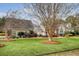Beautifully landscaped property with a well-manicured lawn, mature trees, and an inviting two-story home at 95 Plymouth Ave, Charleston, SC 29412