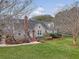 Inviting two-story home with manicured lawn, mature trees, and red brick chimney in a desirable neighborhood at 95 Plymouth Ave, Charleston, SC 29412