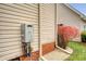Exterior view of the back of a home with vinyl siding and a tankless hot water system at 95 Plymouth Ave, Charleston, SC 29412