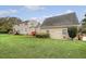 The image captures the back exterior of a house with well-maintained green grass and a lush yard at 95 Plymouth Ave, Charleston, SC 29412