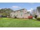 The image captures the back exterior of a house with well-maintained green grass and a lush yard at 95 Plymouth Ave, Charleston, SC 29412