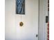 Close-up of a white front door with detailed hardware, adding a touch of elegance at 95 Plymouth Ave, Charleston, SC 29412