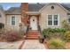 Charming entrance with brick steps, wrought iron railings, and a lovely front door with stone and brick accents at 95 Plymouth Ave, Charleston, SC 29412