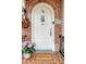 Charming brick archway frames the white front door with a welcome mat and lovely hydrangea accent at 95 Plymouth Ave, Charleston, SC 29412