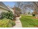 Lush, green front yard featuring a charming stone pathway leading to the well-maintained property at 95 Plymouth Ave, Charleston, SC 29412