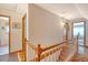 Second floor hallway with wood railing provides access to a full bathroom at 95 Plymouth Ave, Charleston, SC 29412