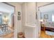 Hallway with wood floors and doors leading to a bedroom and a living room with a dining table at 95 Plymouth Ave, Charleston, SC 29412