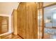 Hallway with multiple built in wooden cabinet doors and gleaming hardwood floors at 95 Plymouth Ave, Charleston, SC 29412