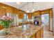 This kitchen includes lots of wood cabinets, stainless steel appliances, and an island cooktop at 95 Plymouth Ave, Charleston, SC 29412