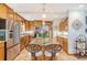 Updated kitchen with a central island with barstools, stainless steel appliances, and wooden cabinetry at 95 Plymouth Ave, Charleston, SC 29412