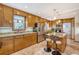 Well-lit kitchen featuring wood cabinets, stainless steel appliances, and an island with bar seating at 95 Plymouth Ave, Charleston, SC 29412