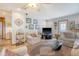 Cozy living room with neutral-toned furniture, area rug, ceiling fan, and plenty of natural light at 95 Plymouth Ave, Charleston, SC 29412