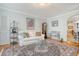 Comfortable living room with neutral-colored walls, hard wood flooring, and a glass coffee table at 95 Plymouth Ave, Charleston, SC 29412
