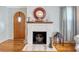 Charming living room features a brick fireplace, hardwood floors, and a decorative arched door at 95 Plymouth Ave, Charleston, SC 29412