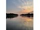 A serene body of water reflects a beautiful and colorful sunset sky at 95 Plymouth Ave, Charleston, SC 29412