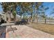 Backyard featuring a brick patio, wooden fence, table and chairs, and mature trees at 101 Danzid Dr, Summerville, SC 29483