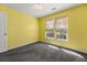 Comfortable bedroom with a double window with blinds, neutral carpet, and a ceiling fan at 101 Danzid Dr, Summerville, SC 29483